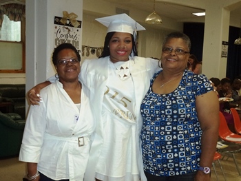 Charde, High School Graduate, with St. Ann's Care Team Teen Mother Graduation from St. Ann's High School