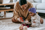 Mother playing with her infant child on carpet