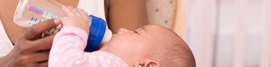 Young Mother feeding her Infant Teen Mother; St. Ann's Center